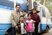 The Feng family in a family photo standing in front of their motor home in Henan.